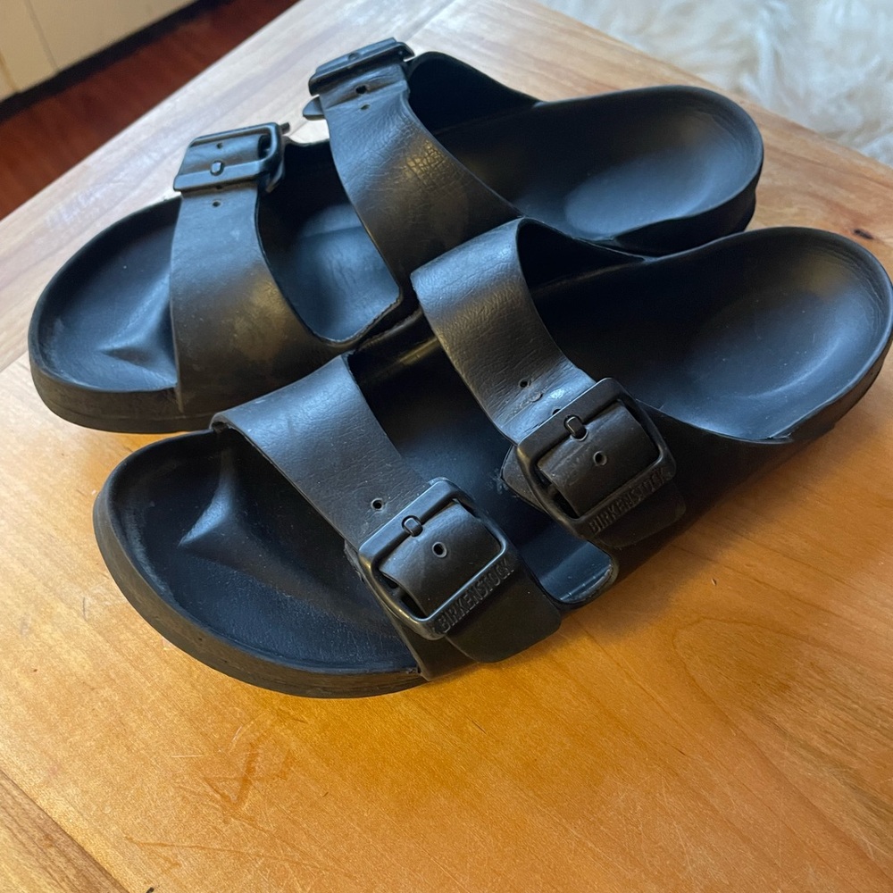 Birkenstock Arizona women’s black plastic sandals.